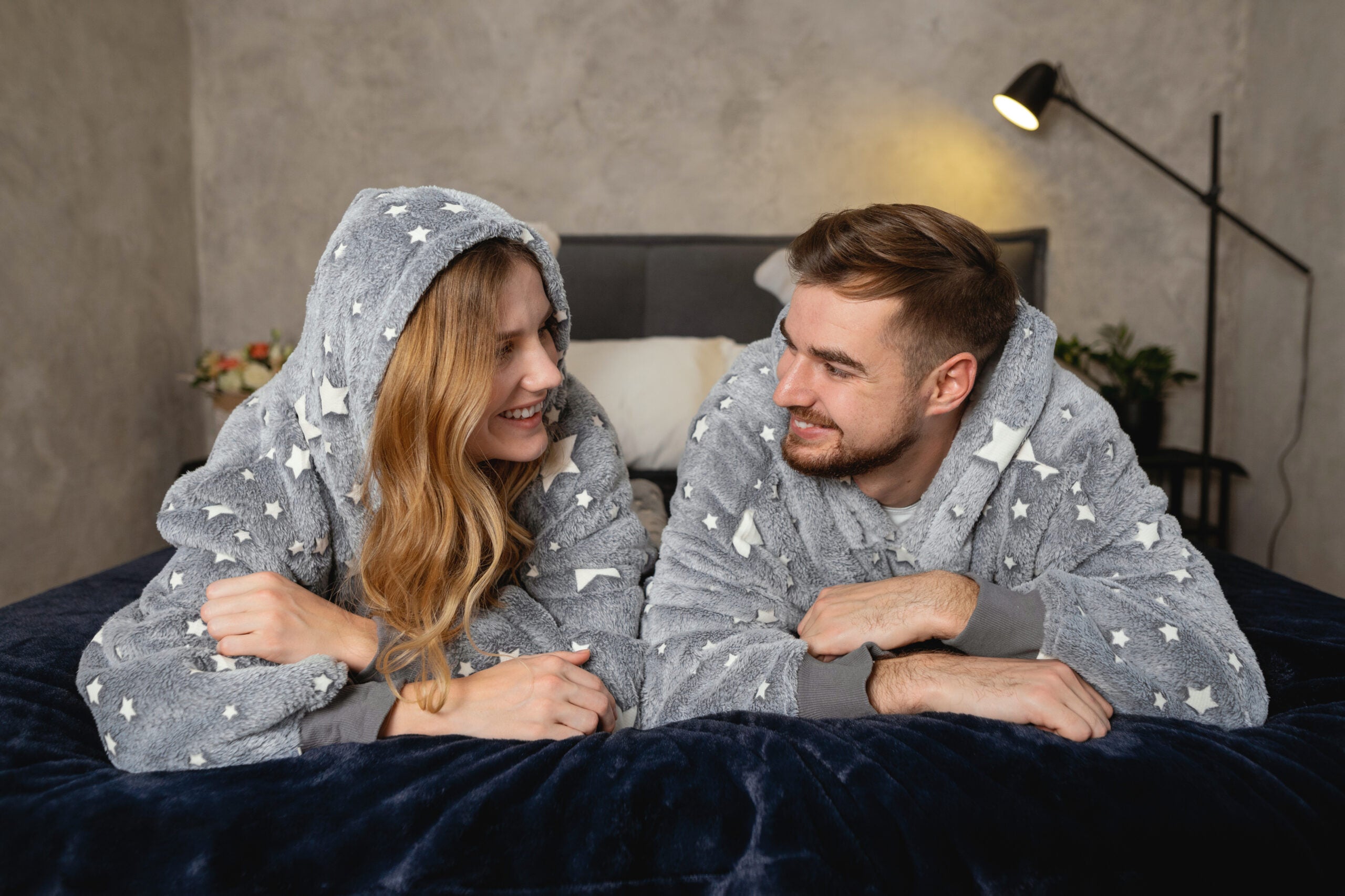 Couple wearing hoodie blankets